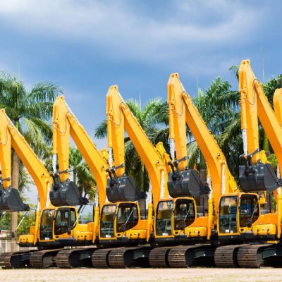 A row of construction equipment for rent that needs construction equipment rental insurance