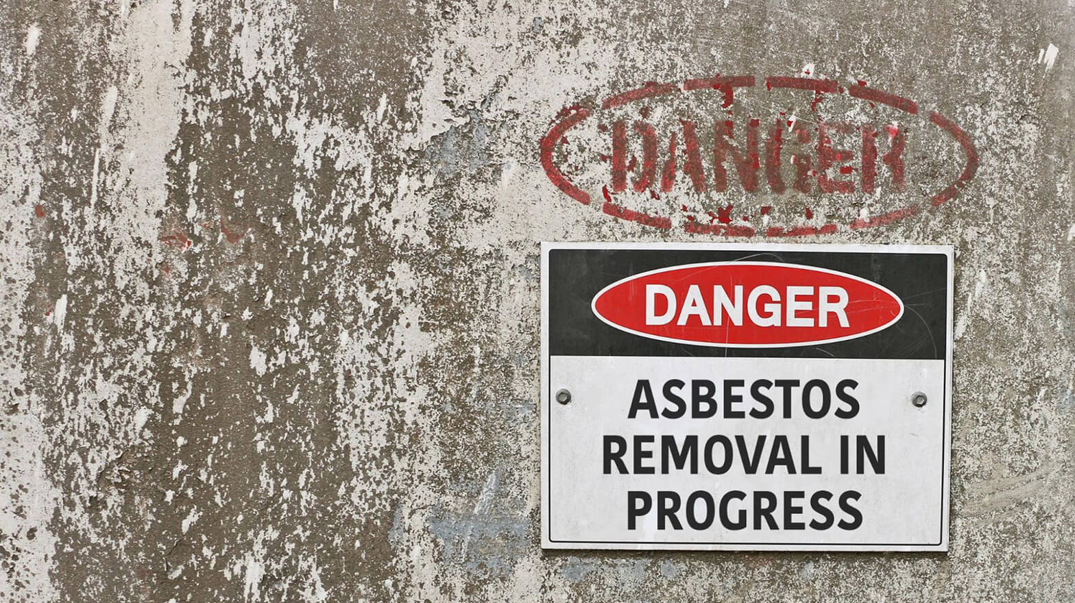 A signage saying “DANGER ASBESTOS REMOVAL IN PROGRESS,” which is an example of construction pollution