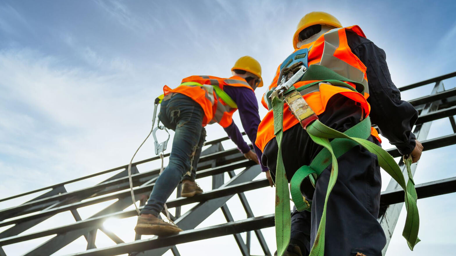 Workers climbing scaffolding owned by a business with scaffolding contractors insurance