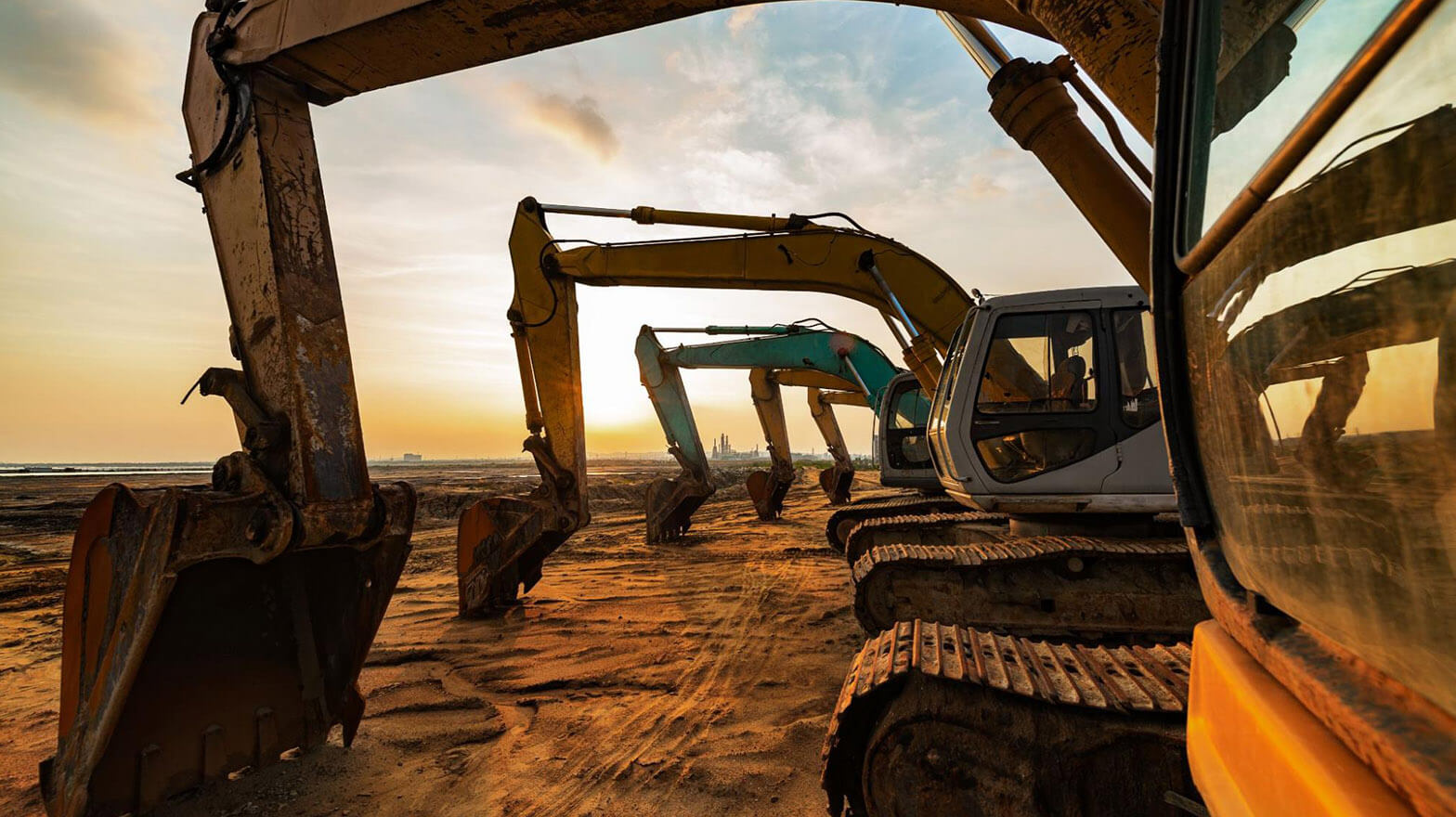 A row of construction equipment covered by heavy equipment insurance