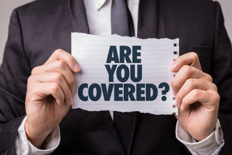  Image of a man with a sign that says “Are you covered?”