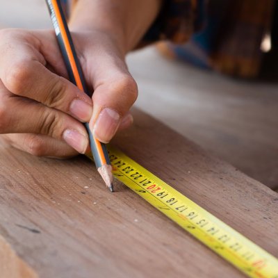 A man measuring a piece of wood