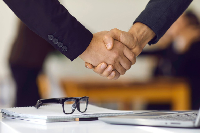  Two people shaking hands after reaching an agreement