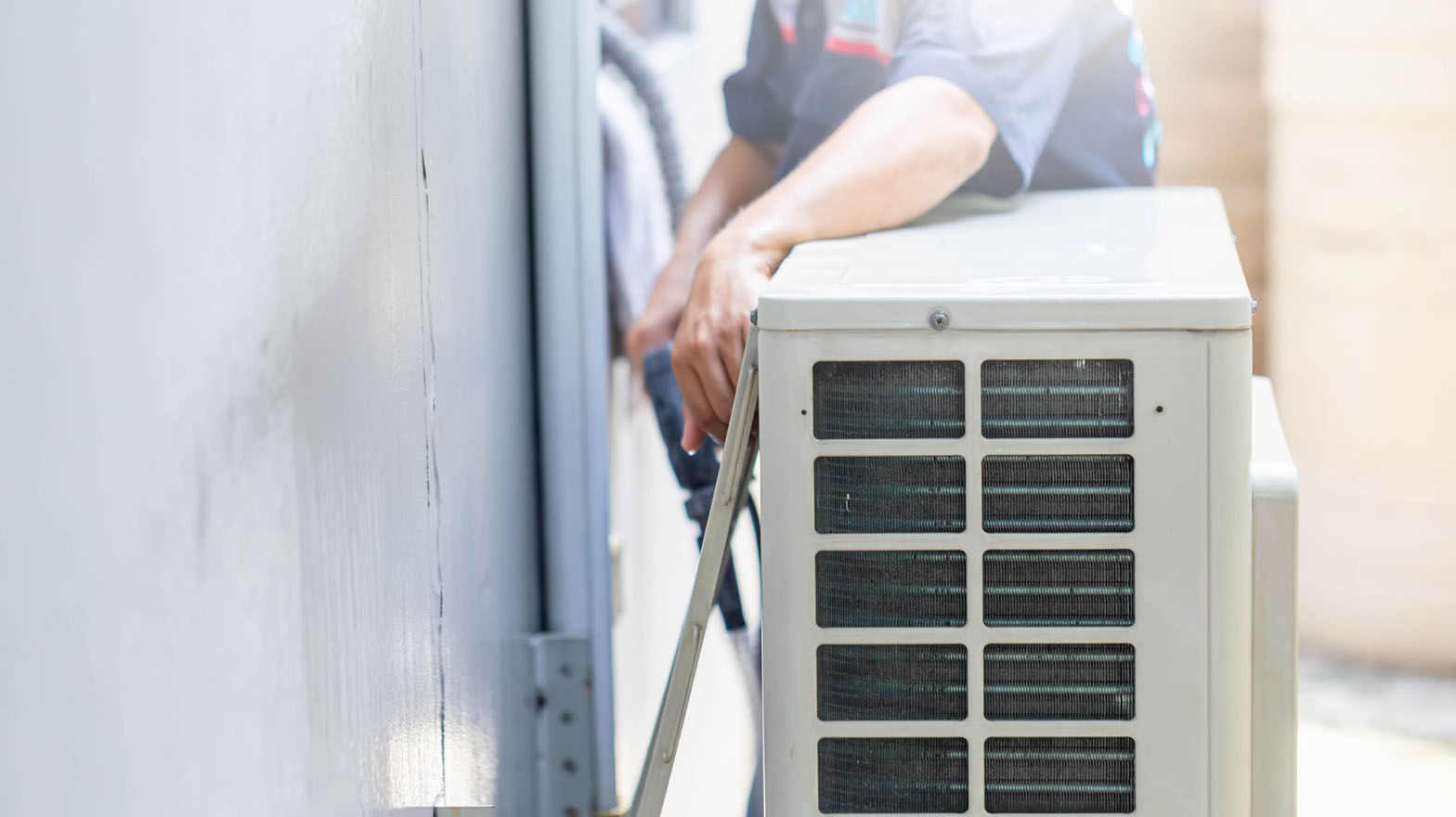 A contractor repairing an air conditioning unit