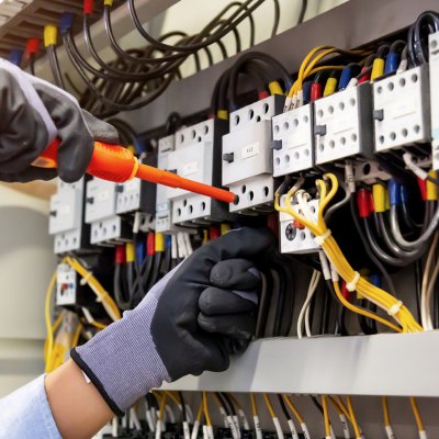 Electrician working on an electrical panel