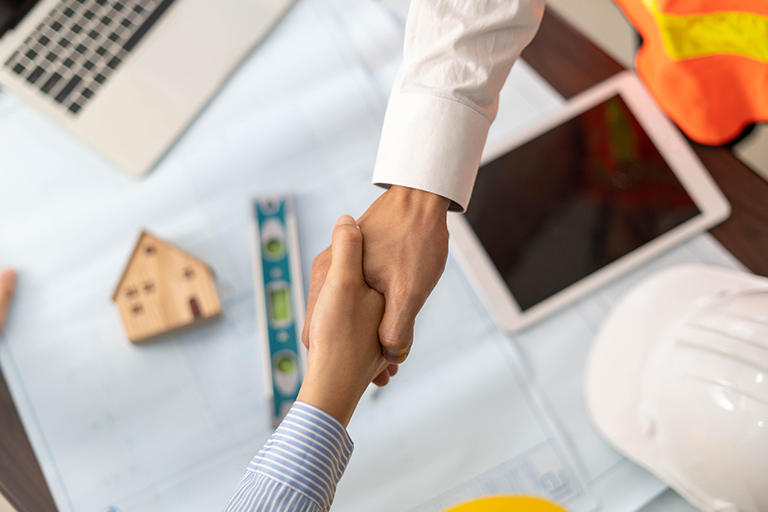 Contractor shaking hands with client