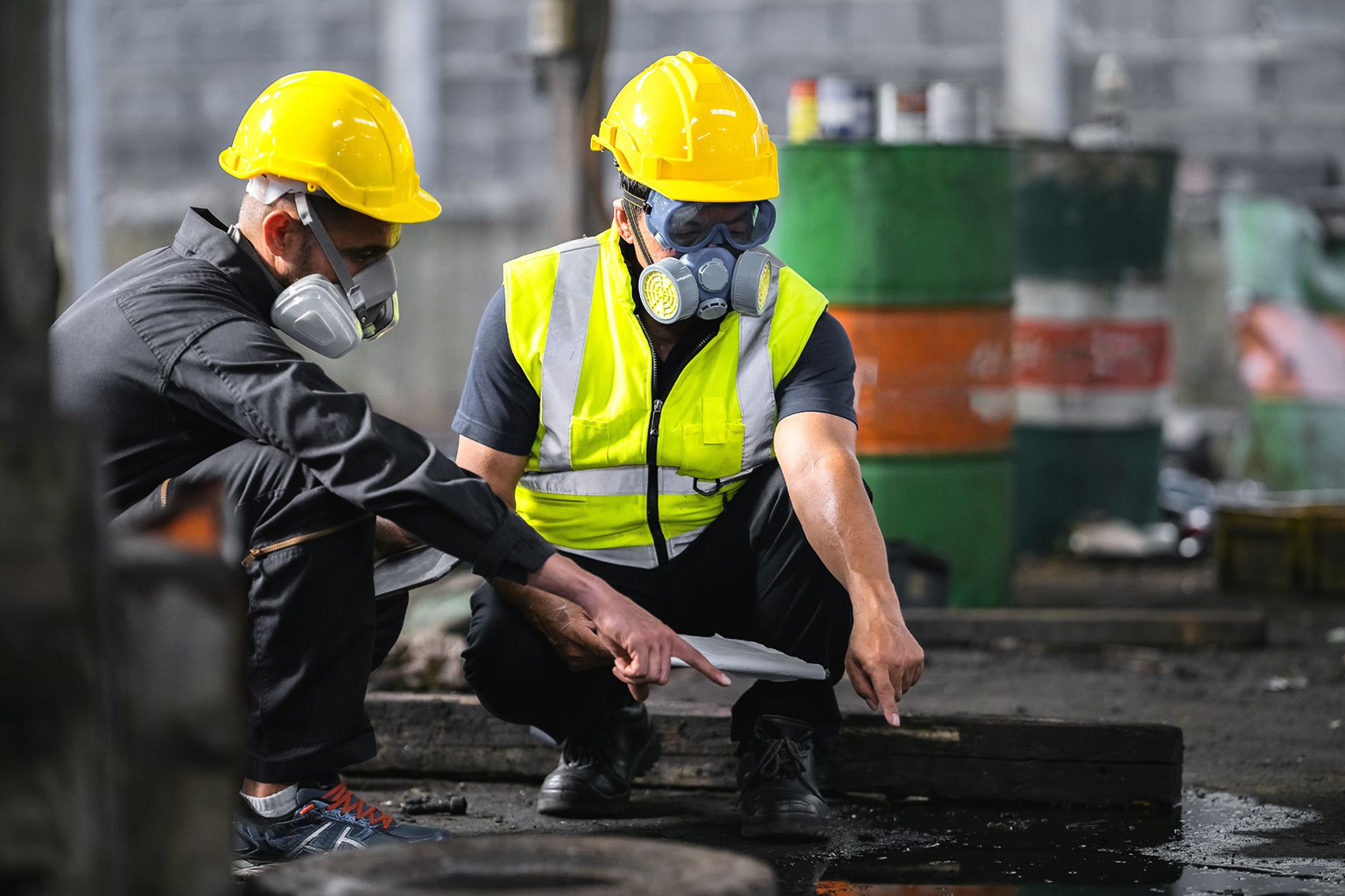 Two officers wearing gas masks inspected the area of a chemical leak at a construction site