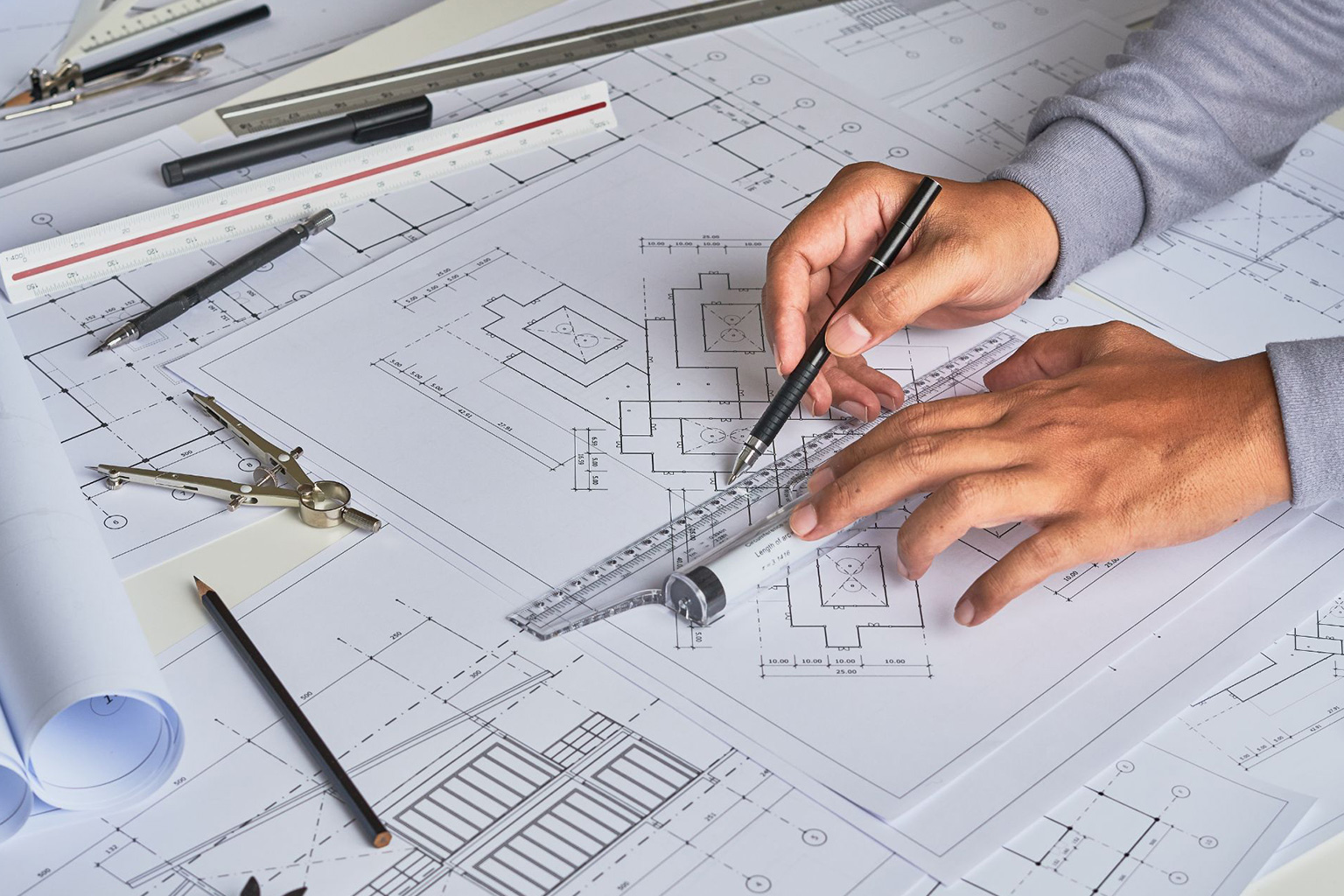 An architect drawing floorplans